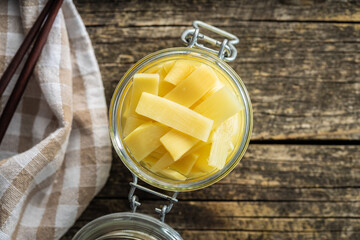 Sliced canned bamboo shoots in jar.