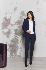 Young business woman in a stylish blue suit and white blouse. Business fashion concept