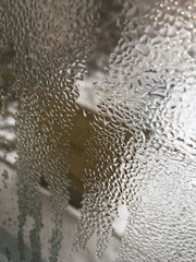 view from the window wet glass covered with wet flowing water, snow melts water drops