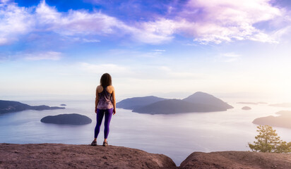 Adventurous Caucasian Adult Woman hiking on top of a mountain. Summer Sunset Sky Art Render. Tunnel Bluffs Hike, North of Vancouver, BC, Canada.