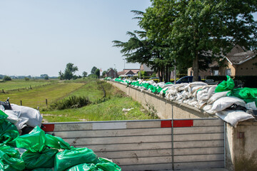 Fence and sandbags on the dike of Heppeneert  in Belgium to prevent flooding of the river Maas.
