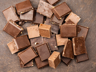 assorted chocolates on a dark table. Chocolate bar. Top view