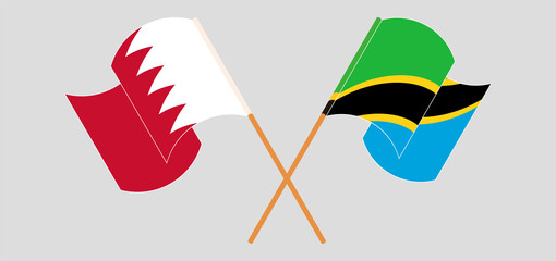 Crossed and waving flags of Bahrain and Tanzania