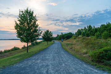 Road at the Markkleeberger lake at sunset in summer