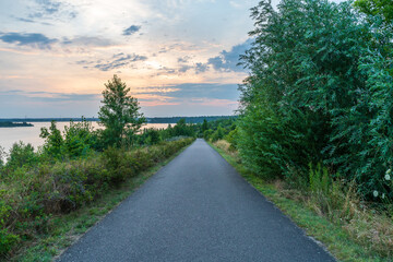 Road at the Markkleeberger lake at sunset in summer