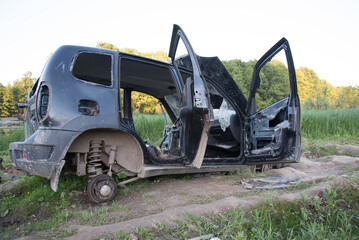 A wrecked car, abandoned on the road. A stolen car
