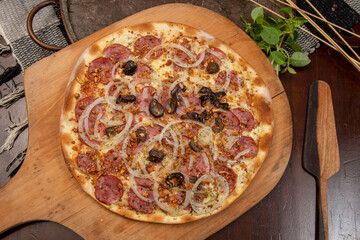 Brazilian pizza with pepperoni, cheese, onion and black olive