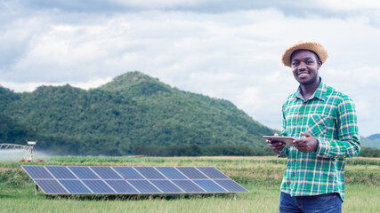 Smart african farmer use tablet , solar cell and innovation technology system for organic farm.Agriculture or cultivation concept