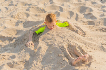 young boy on the beach on a sunny day