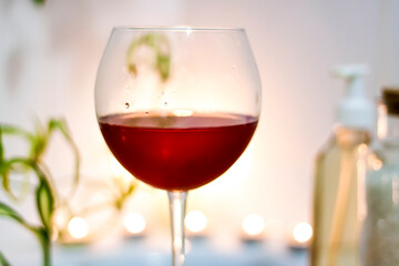 Spa-beauty salon, wellness center. Spa treatment aromatherapy for the female body in the bathroom with a glass of wine, with candles, oils and salt