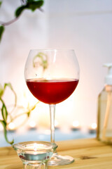 Spa-beauty salon, wellness center. Spa treatment aromatherapy for the female body in the bathroom with a glass of wine, with candles, oils and salt