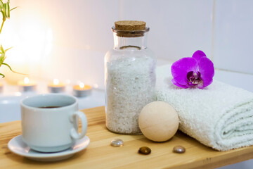 Fototapeta na wymiar Spa-beauty salon, wellness center. Aromatherapy spa treatment for the female body in the bathroom with a cup of coffee, candles, oils and salt.