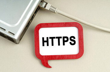 There is a router connected to the network on the table, next to a sign that says - HTTPS