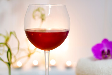 Spa-beauty salon, wellness center. Spa treatment aromatherapy for the female body in the bathroom with a glass of wine, with candles, oils and salt