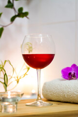Spa-beauty salon, wellness center. Spa treatment aromatherapy for the female body in the bathroom with a glass of wine, with candles, oils and salt