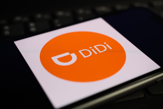 Viersen, Germany - June 1. 2021: Closeup of mobile phone screen with logo lettering of didi pay on computer keyboard