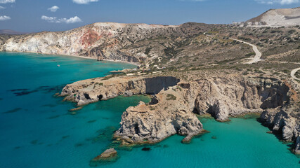 Obraz premium Aerial drone photo of beautiful volcanic emerald paradise bay and sandy beach of Tsigrado below white rock with perlite mine, Milos island, Cyclades, Greece