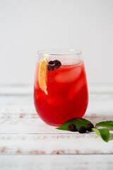 Close Up of a Glass of Homemade Blackberry Lemonade on White Background