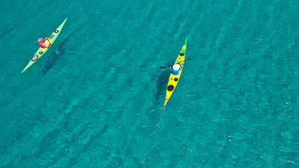 Aerial drone photo of team of young women practice on sport kayak in tropical exotic bay with emerald crystal clear sea