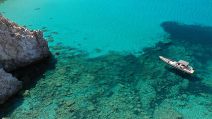 Aerial drone photo of catamaran sailing yacht anchored in tropical exotic emerald sea coral reef bay