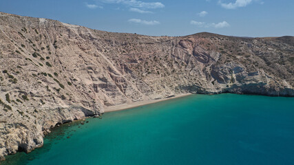 Aerial drone photo of secluded paradise sandy beach of Kalamos mostly covered by perlite rock only accessible by boat, Milos island, Cyclades, Greece
