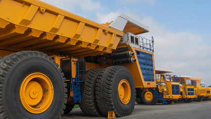 Big yellow mining truck. Details of the construction of a mining dump truck. Industry concept.