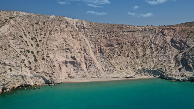 Aerial drone photo of secluded paradise sandy beach of Kalamos mostly covered by perlite rock only accessible by boat, Milos island, Cyclades, Greece