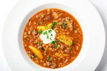 Rassolnik with pickled cucumbers, barley, meat decorated greenery.