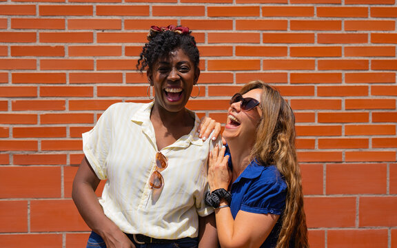 Happy multiethnic women laughing at joke