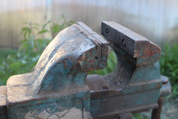 old locksmith vise in the yard of the house