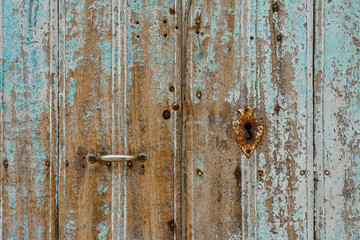Antique wooden door with rusted hardware