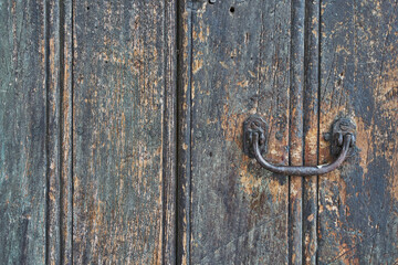 Antique wooden door with rusted hardware