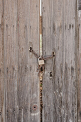 Antique wooden door with rusted hardware