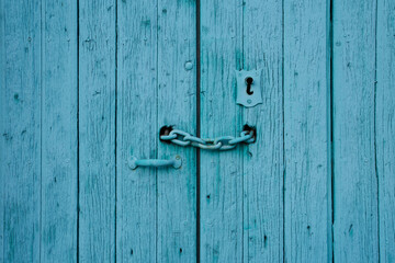 Antique wooden door with rusted hardware