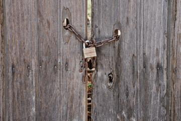 Antique wooden door with rusted hardware