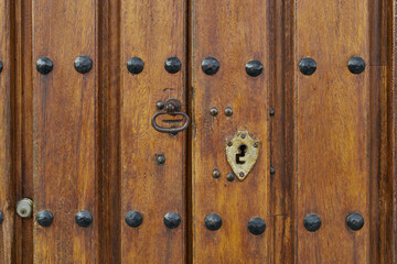 Antique wooden door with rusted hardware