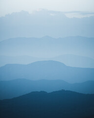 layered background of mountains at blue hour © serozstock