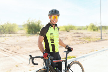 Portrait of a happy handsome athlete cycling