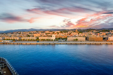 Naklejka premium View from a cruise ship of the port and skyline of Messina on the island of Sicily, the main tourist hub for cruise lines, under a colorful sky.