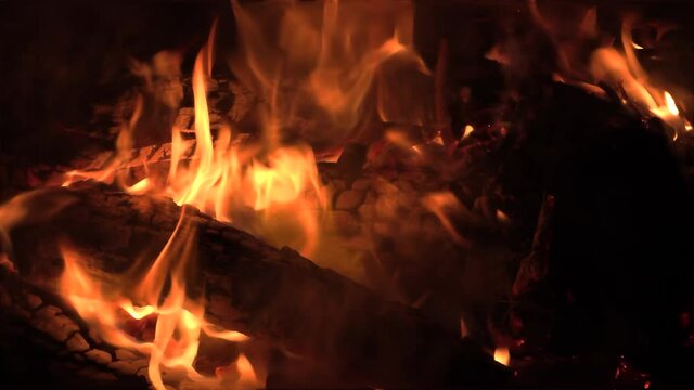 Zoom on oak logs on fire at night, orange flames. wood fire Stock Footage 4k UHD 50 FPS