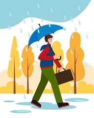 Man with umbrella in park in Autumn rain weather