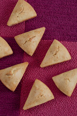 Cornbread cut into triangles on purple tiled background