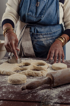 Woman chef cutting biscuits out of dough