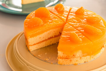 Homemade orange cake which cutting to serve