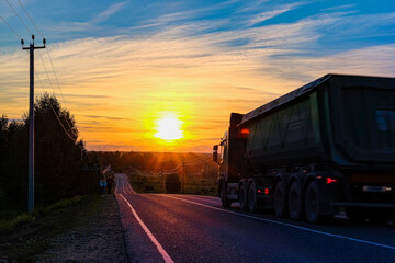 Moscow region, Russia - June, 16, 2021:  trucks on a country road in Moscow region at sunset