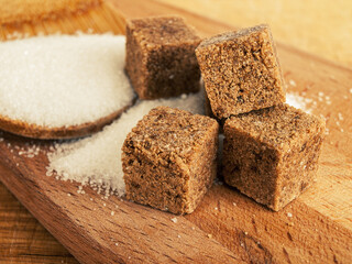 Dark sugar in cubes and white crystalline sugar, refined sugar, the difference between cane and beet sugar, confectionery