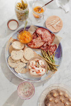 Southern style charcuterie with peach preserves, benne seed crackers, country ham, pickled shrimp and pickled green beans