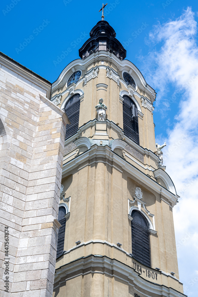 Wall mural a beautiful tower in przemyśl with a clock with sculptures.