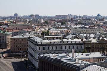 Obraz premium panoramic top view of the roofs of buildings in the historical part of the city and the blue sky on a sunny summer day and a copy space in Saint-Petersburg Russia