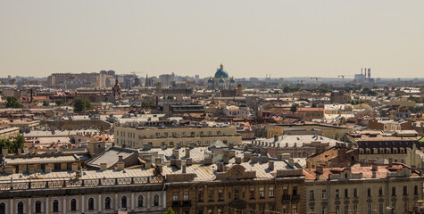Fototapeta premium panoramic top view of the roofs of buildings in the historical part of the city and the blue sky on a sunny summer day and a copy space in Saint-Petersburg Russia